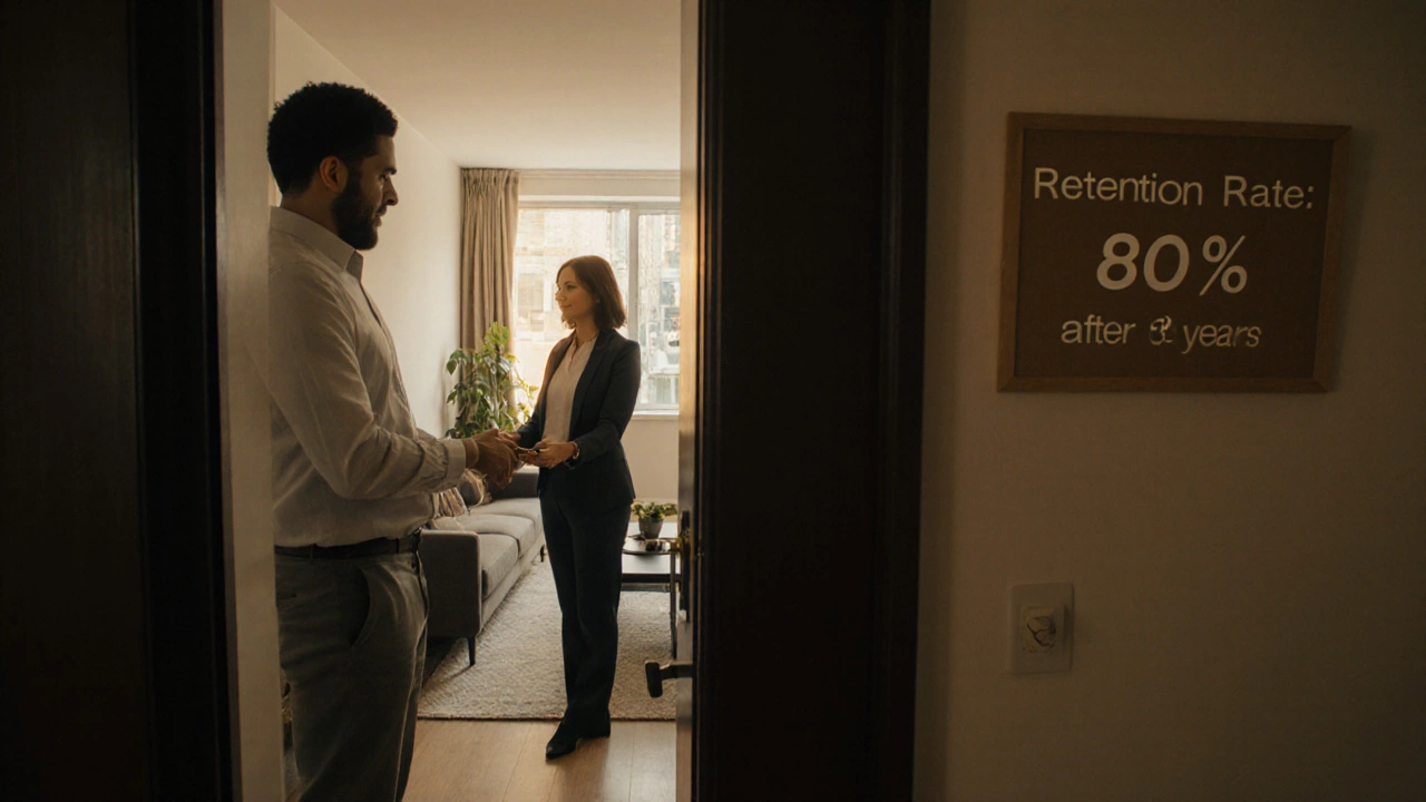 Client receiving apartment keys from a case manager in a well-lit new unit.